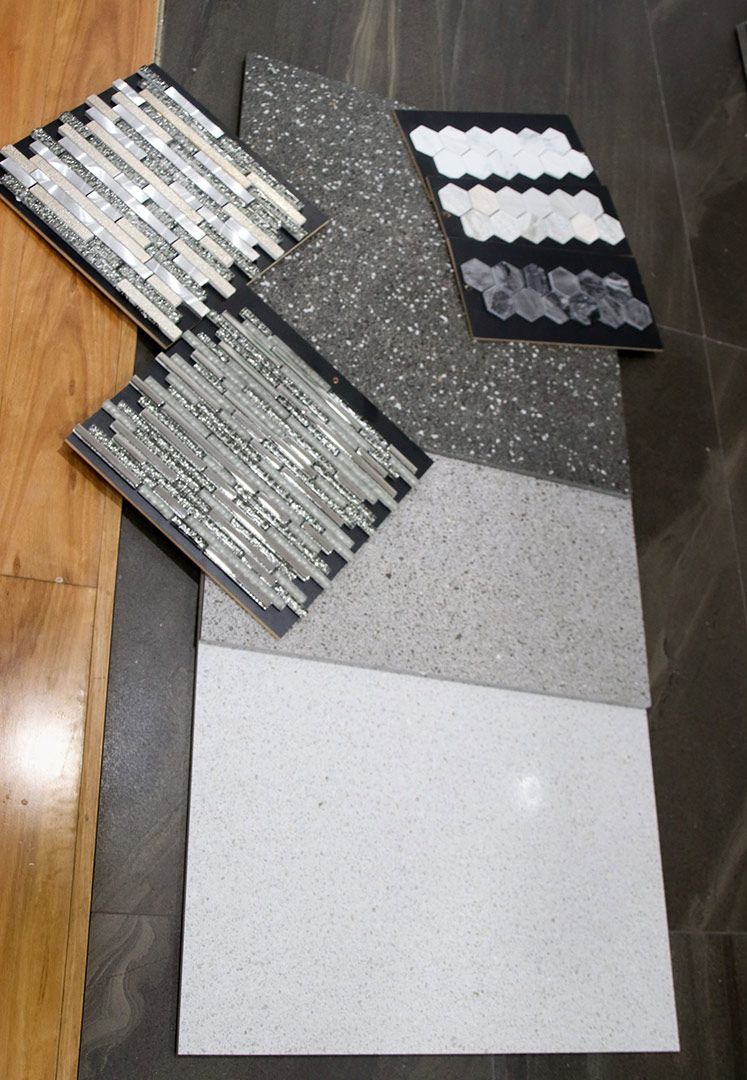 A Bunch of Tiles Are Laying on A Wooden Floor — Traditional Tiles & Flooring In Woree, QLD