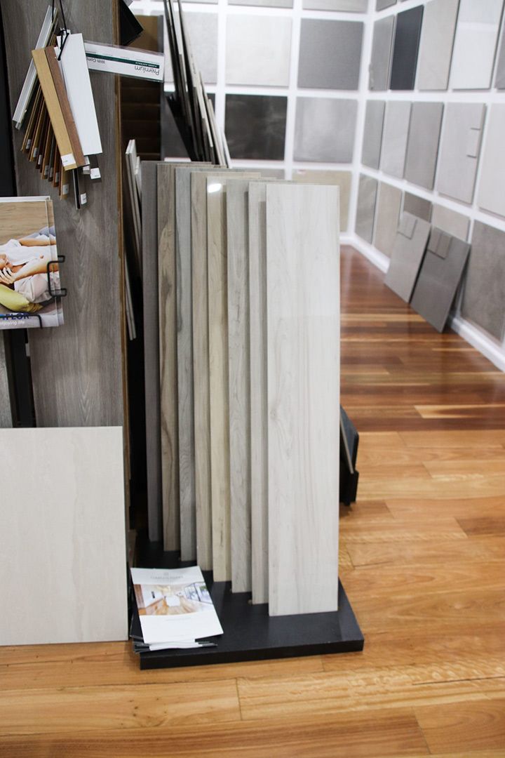 A Display of Tiles on A Wooden Floor in A Store — Traditional Tiles & Flooring In Woree, QLD