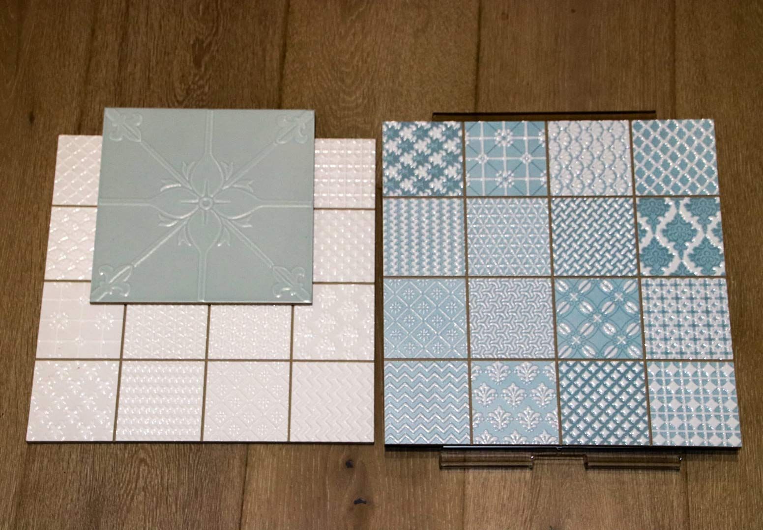 Two Tiles with Different Patterns Are Sitting on A Wooden Table — Traditional Tiles & Flooring In Woree, QLD
