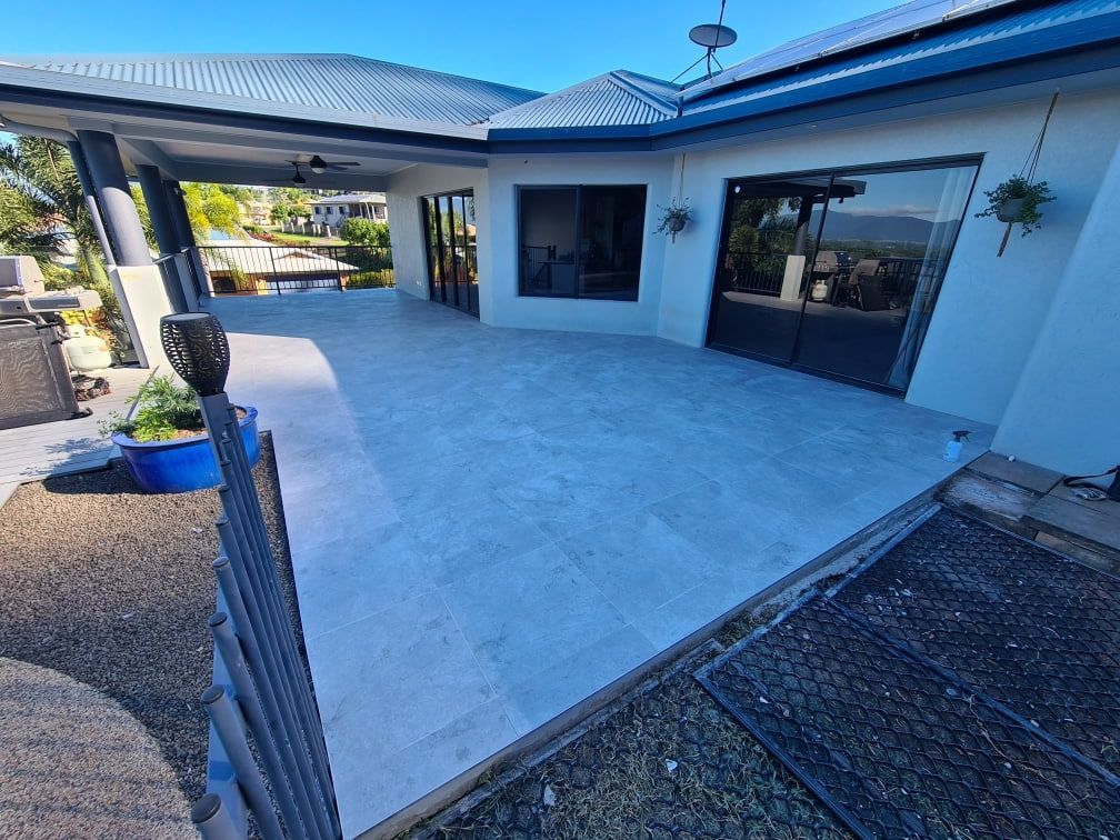 A Large White House with A Large Patio in Front of It — Traditional Tiles & Flooring In Woree, QLD