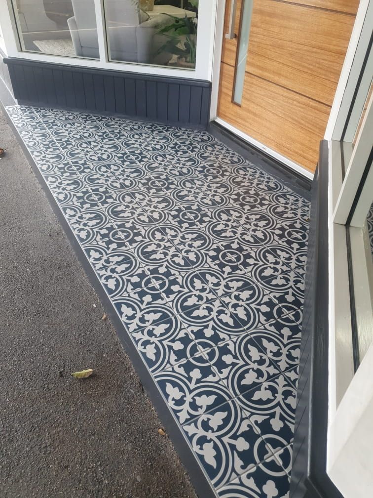 A Black and White Tile Floor in Front of A House — Traditional Tiles & Flooring In Woree, QLD