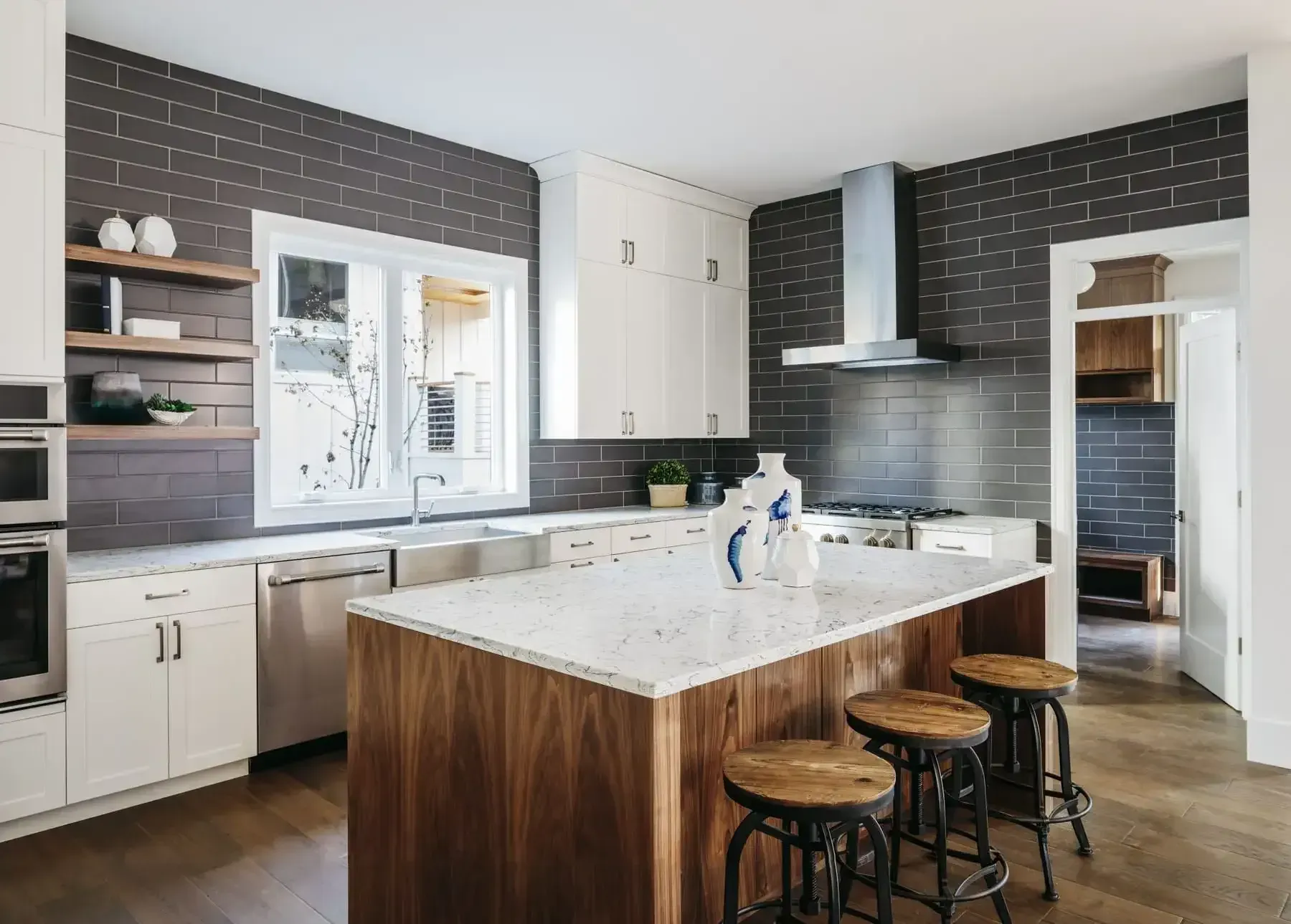A Kitchen With a Large Island and Stools — Traditional Tiles & Flooring in Palm Cove, QLD