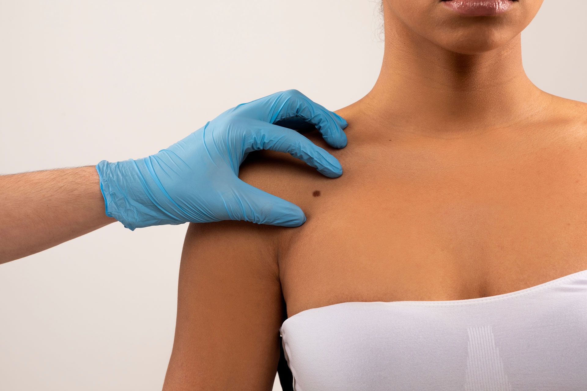A woman is getting her skin examined by a doctor.