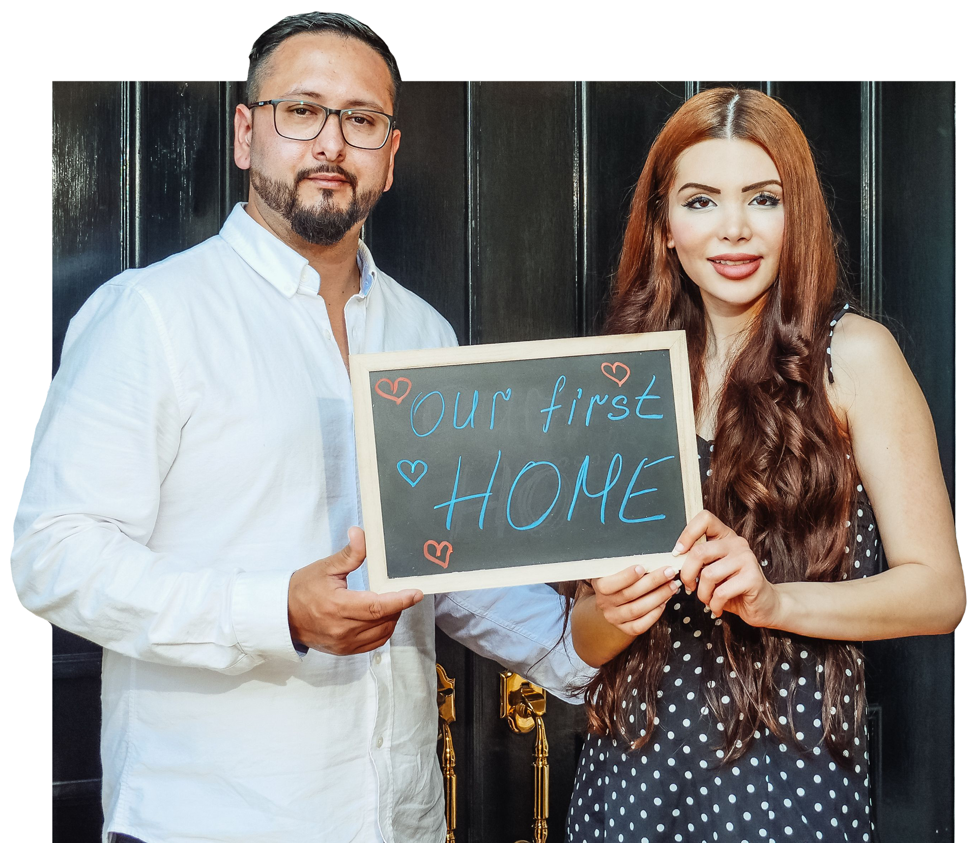 Two people holding a chalkboard sign reading 