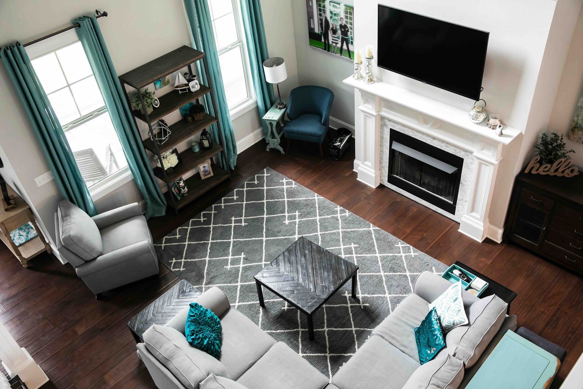 an aerial view of a living room filled with furniture and a fireplace.