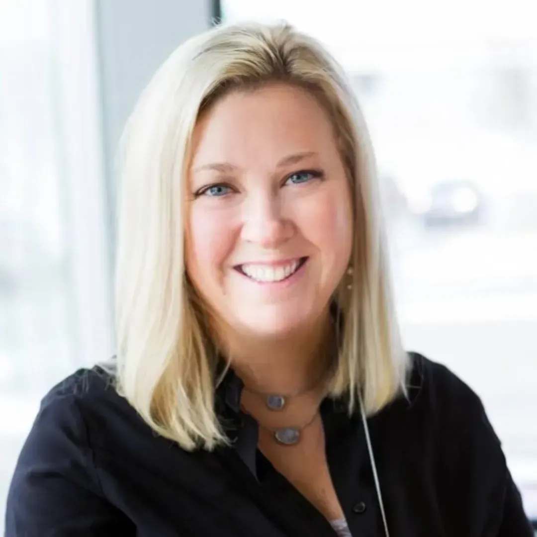 Kara Marsman is smiling and wearing a black shirt.