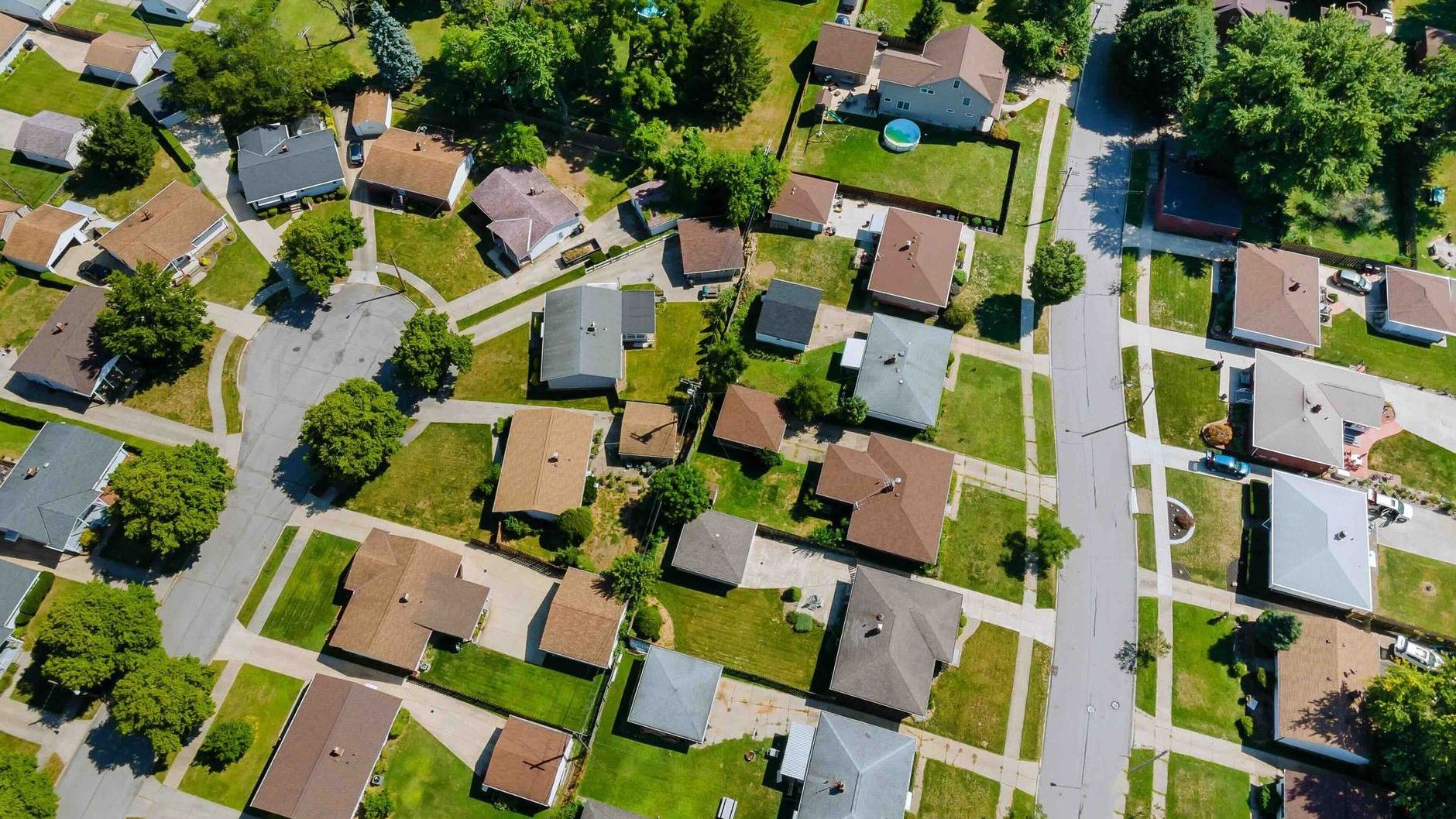 an aerial view of a residential neighborhood with lots of houses and trees.
