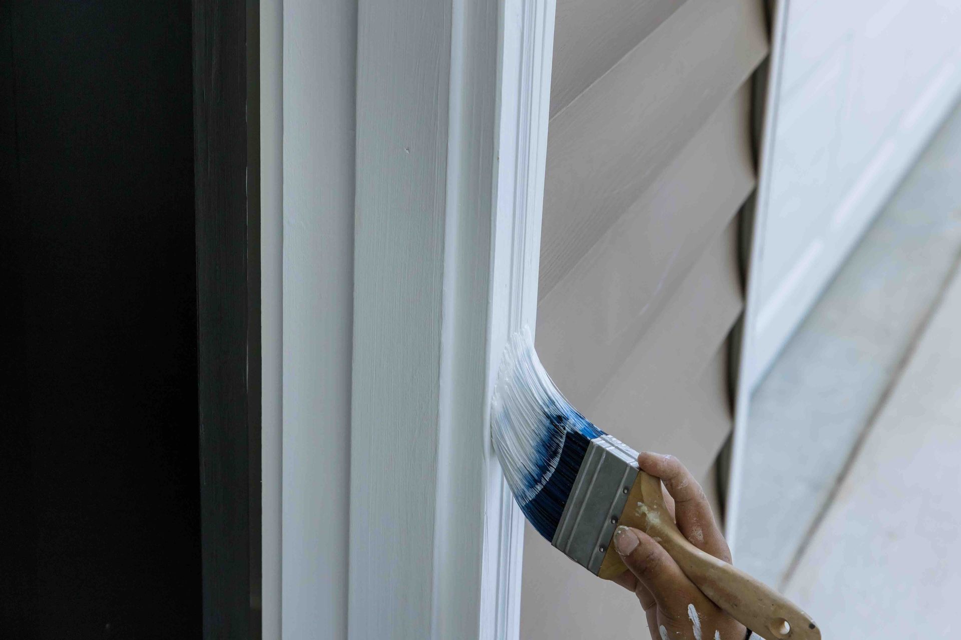 A person is painting a door with a brush.