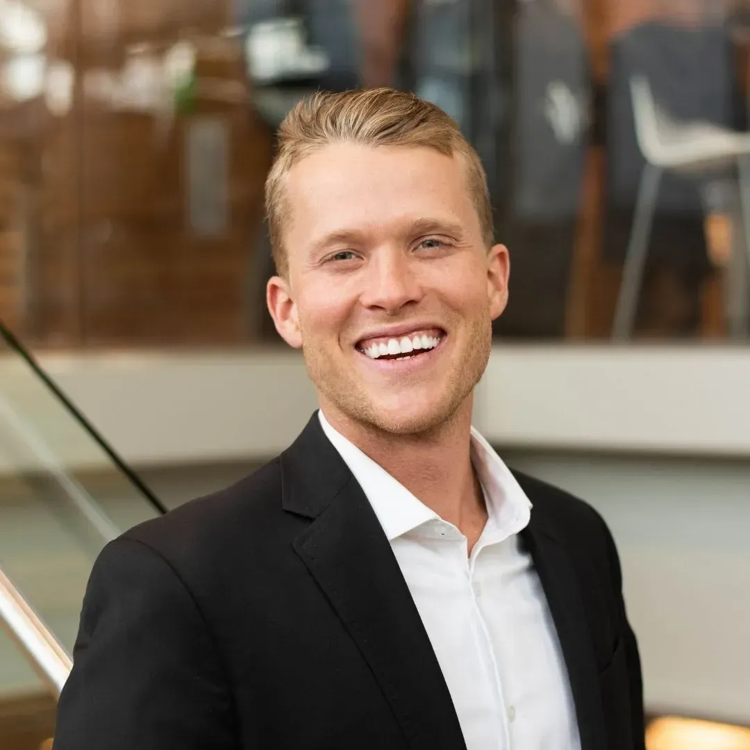 image of tim bowditch in a white shirt and black suit jacket.