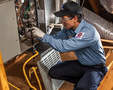man closing lid on furnance