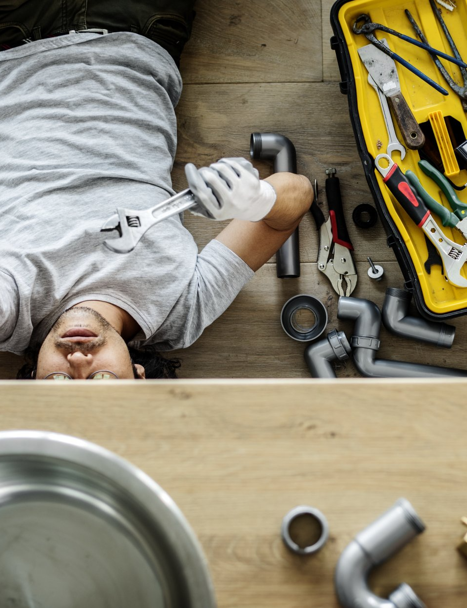 man fixing kitchen sink