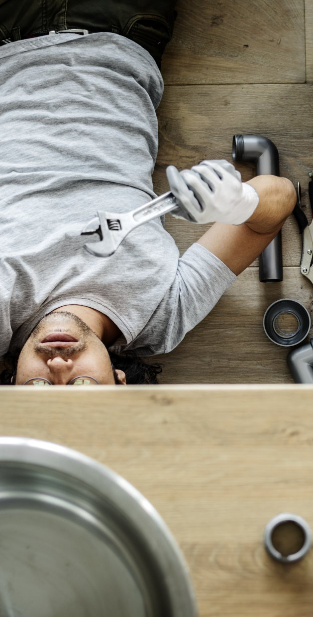 man fixing kitchen sink