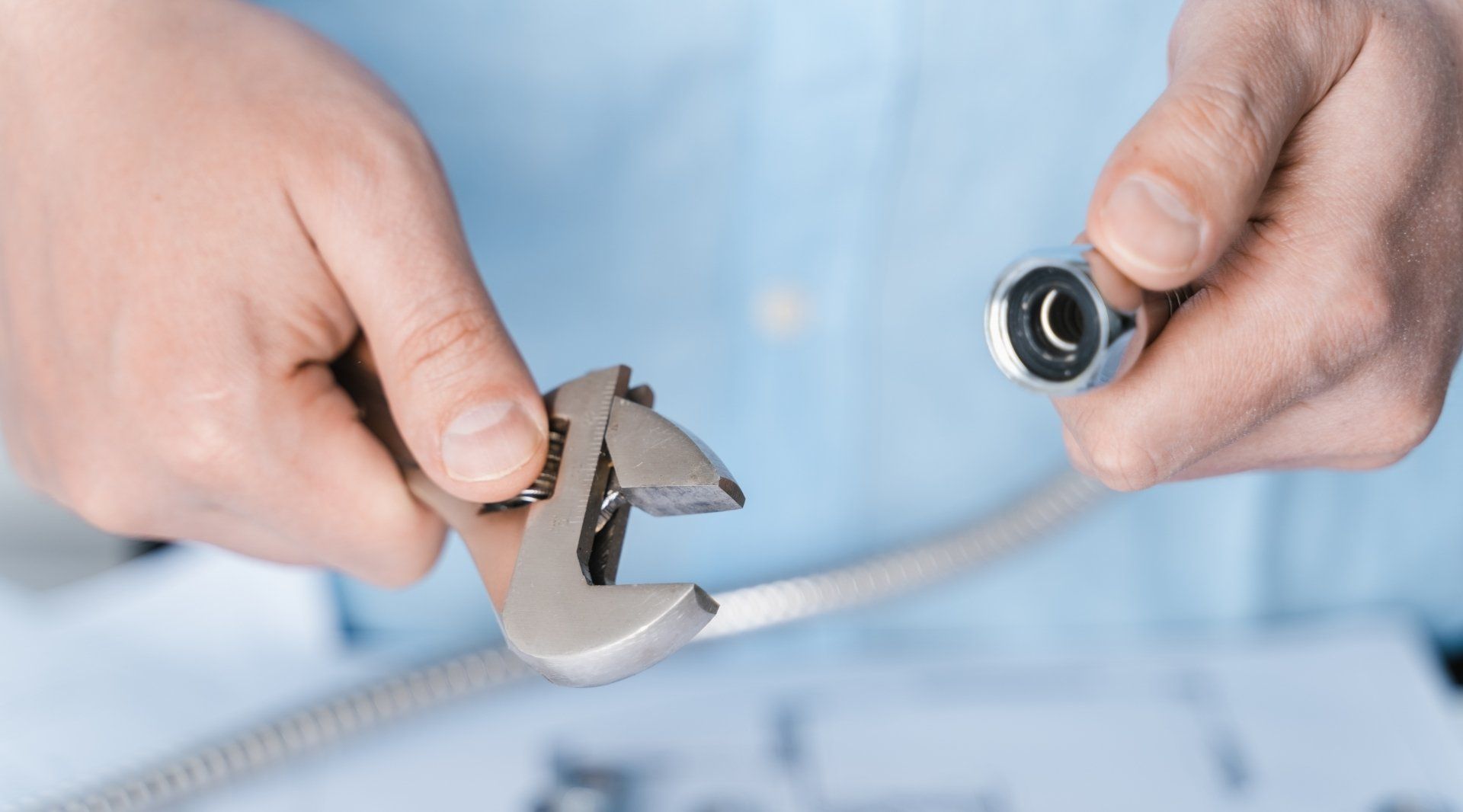 hose pipe and a wrench in hands