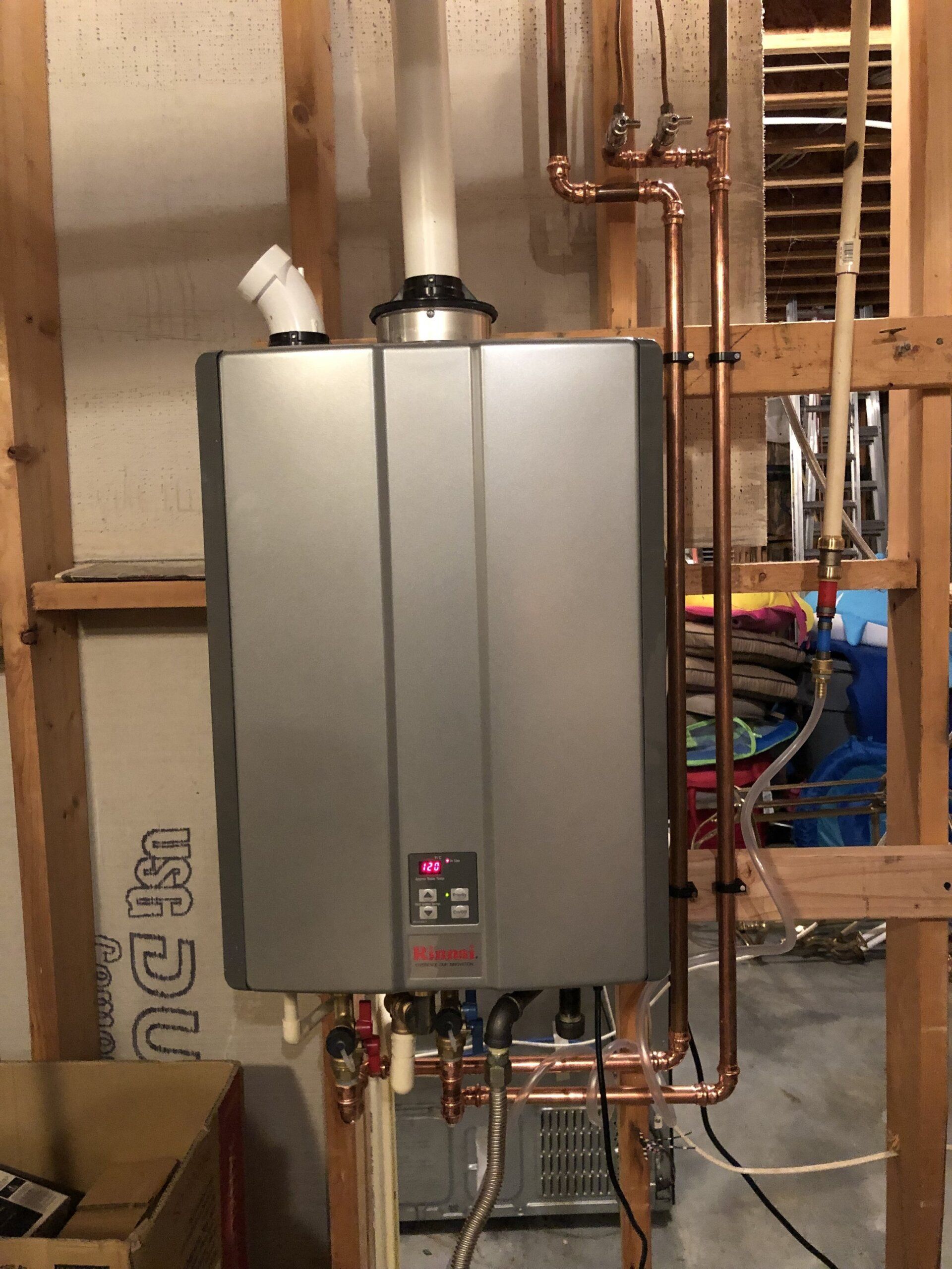 person adjusting knobs on water heater