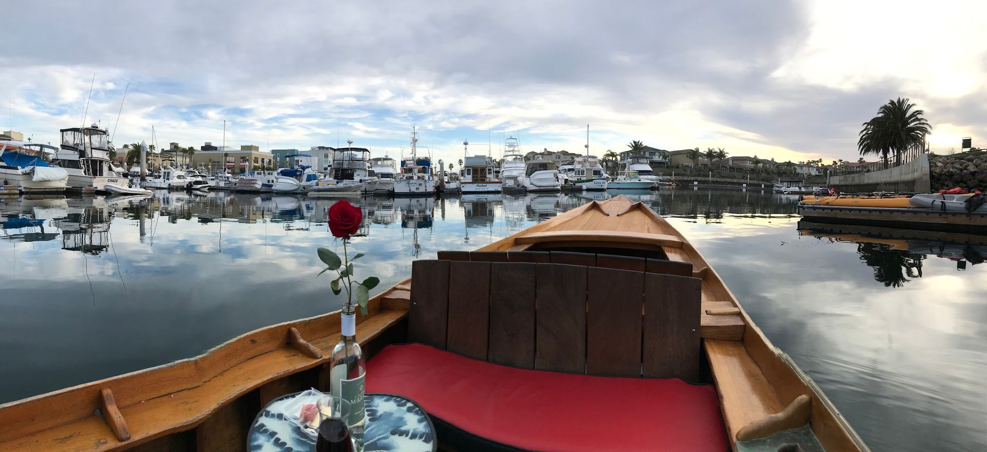 A boat with a rose in the middle of the water.