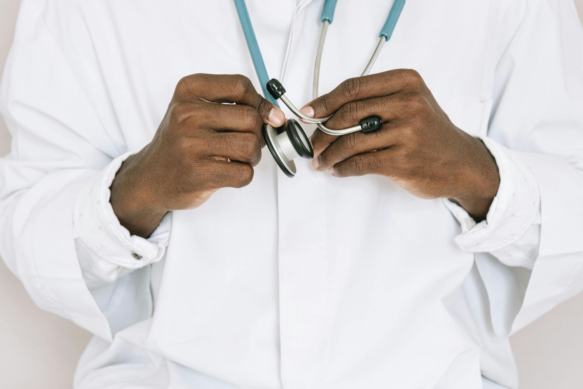 A doctor is holding a stethoscope around his neck.