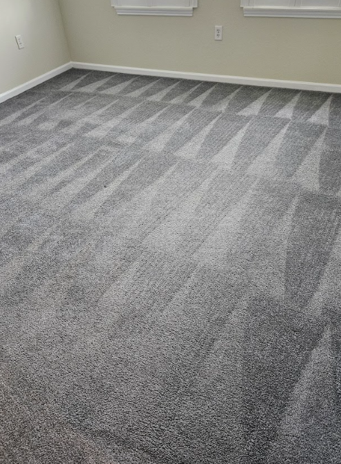 Empty room with gray patterned carpet and beige walls