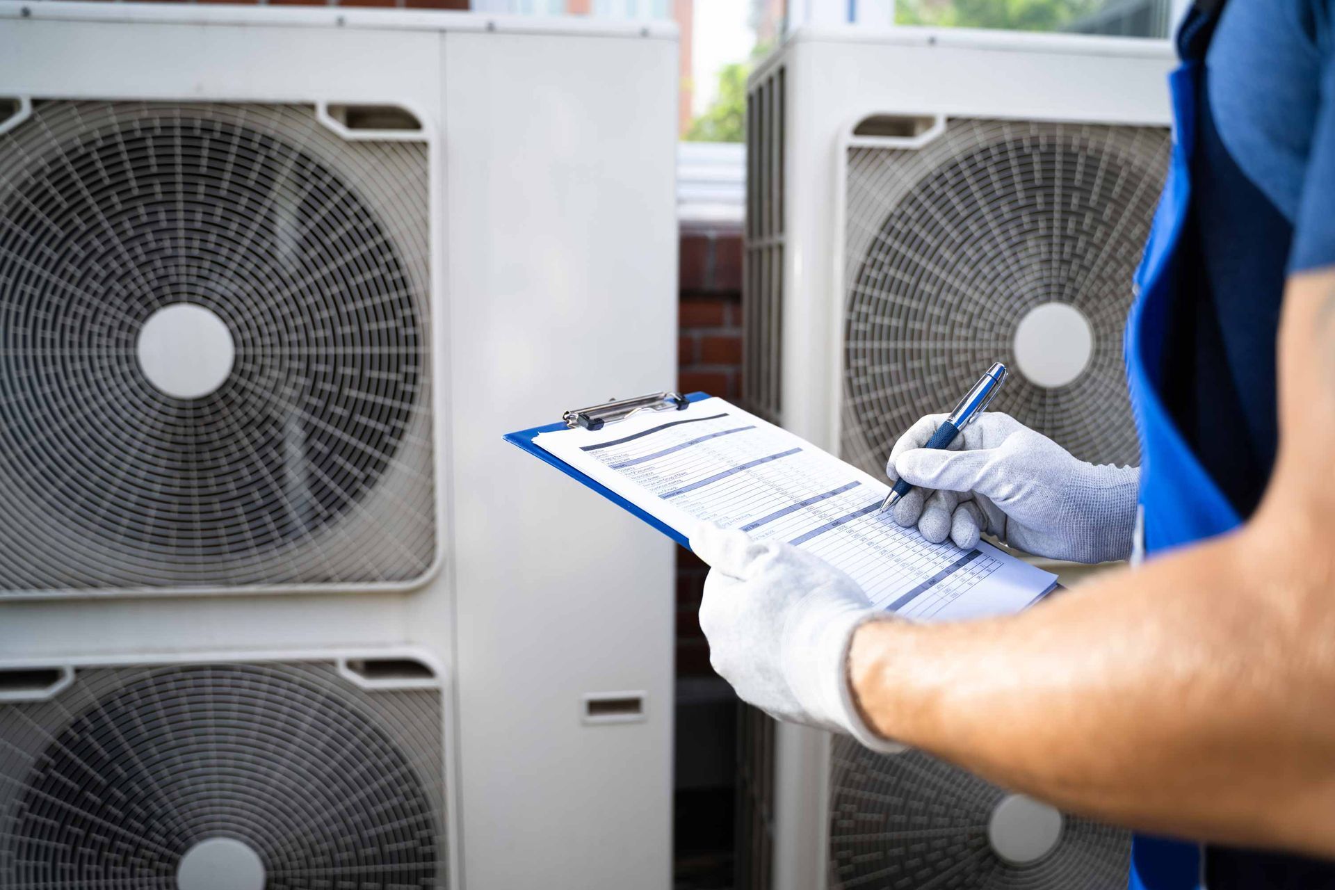 HVAC contractor checking an air conditioning unit.