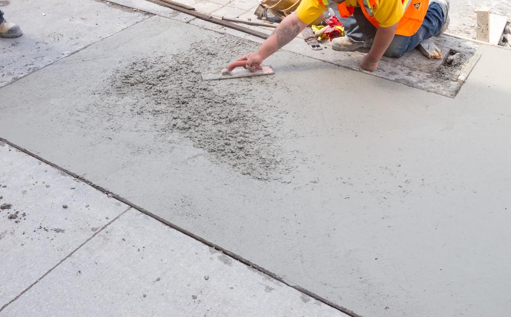 Worker Smoothing Cement Floor Slab — Quality Constructions in Gympie, QLD