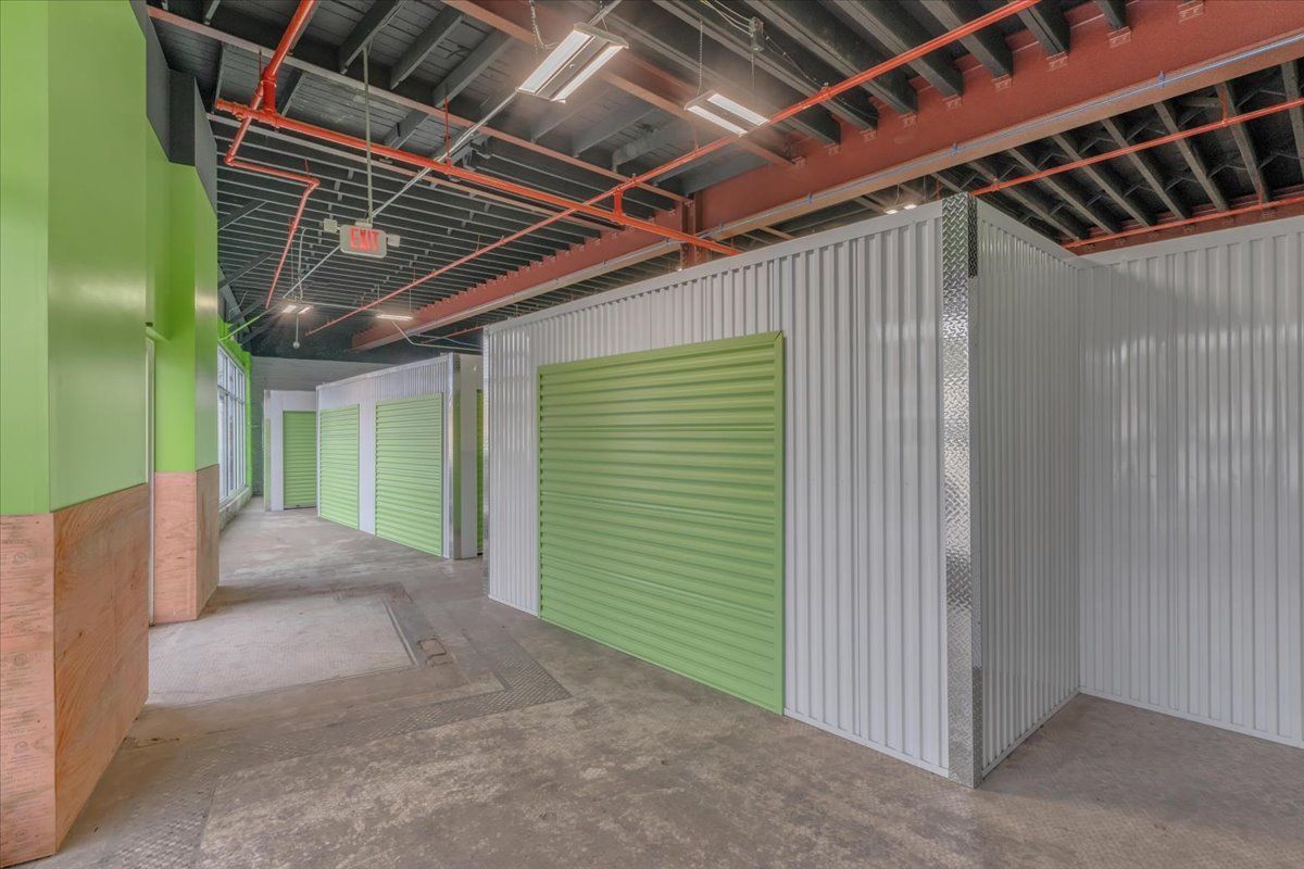 Interior view of a storage facility with green doors and walls.