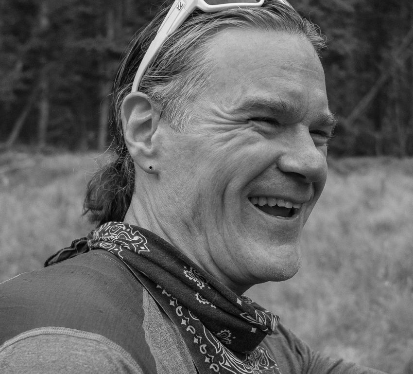 Stu Swineford headshot - laughing outdoors