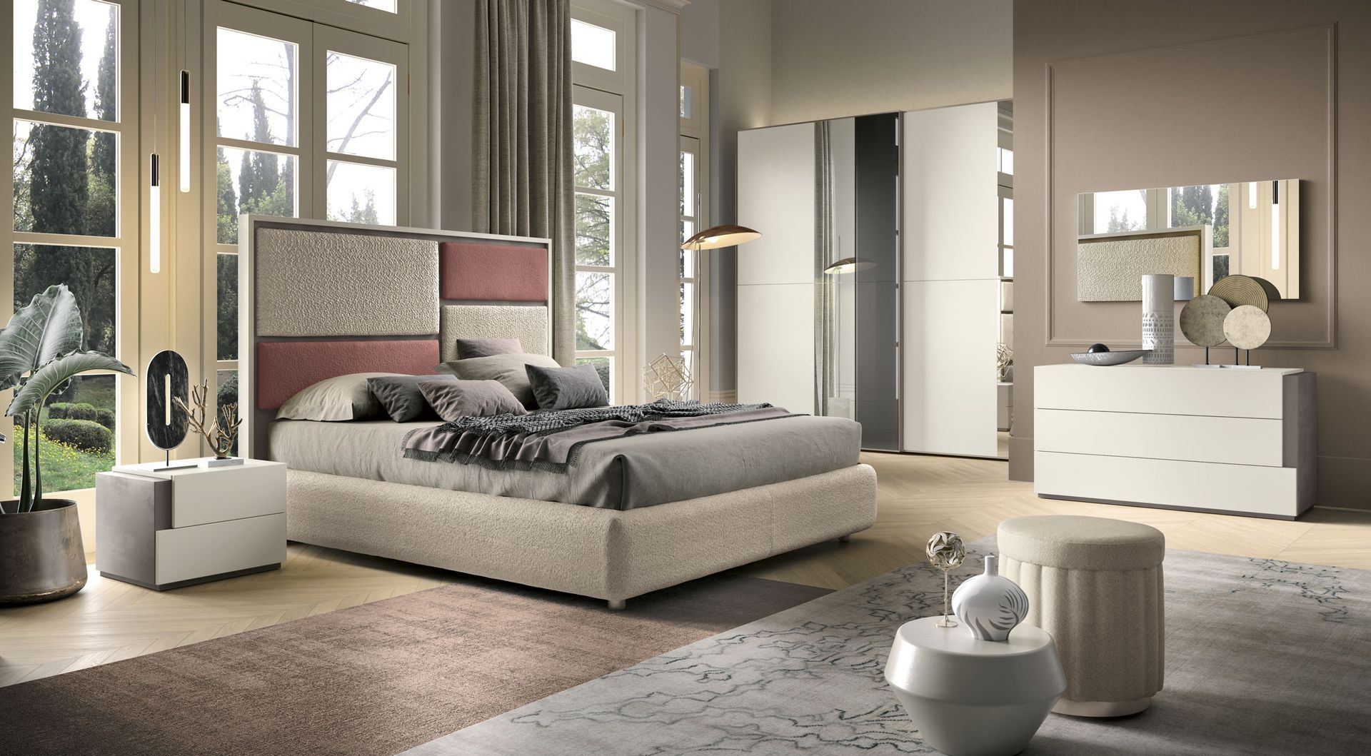 Elegante camera da letto con letto, cassettiera e comodino in tonalità neutre e tappeto a fantasia.