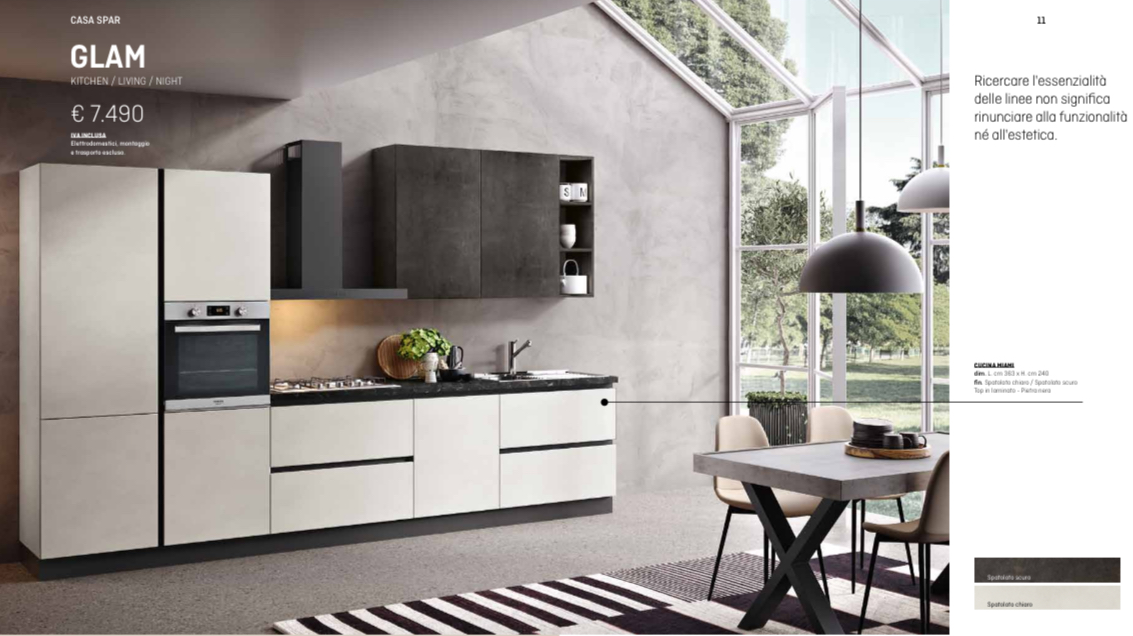 Cucina moderna con mobili color crema e grigio scuro, forno, piano cottura e tavolo da pranzo.