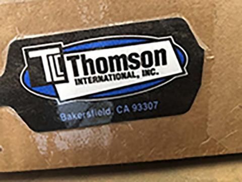 A close up of a thomson international inc. sticker on a box.