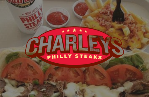 A charley 's philly steaks logo with a sandwich and french fries in the background