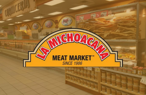 The logo for la michoacana meat market is displayed in front of a grocery store.