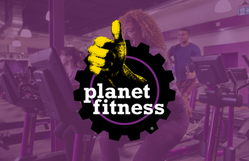 A woman is giving a thumbs up in a planet fitness gym.