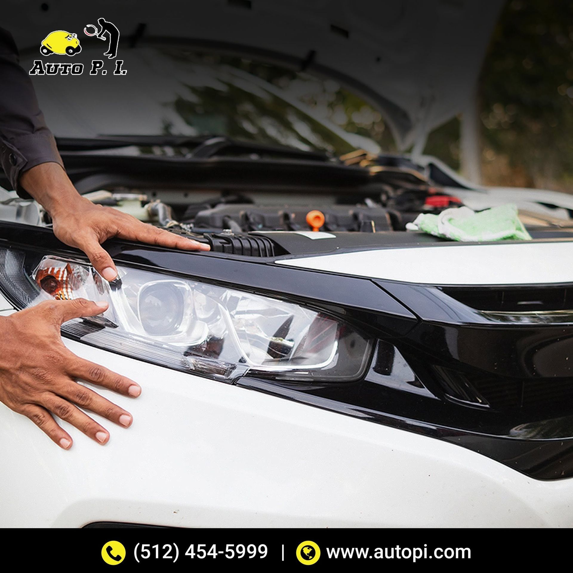 Hands installing a car headlight on a white vehicle in a garage.
