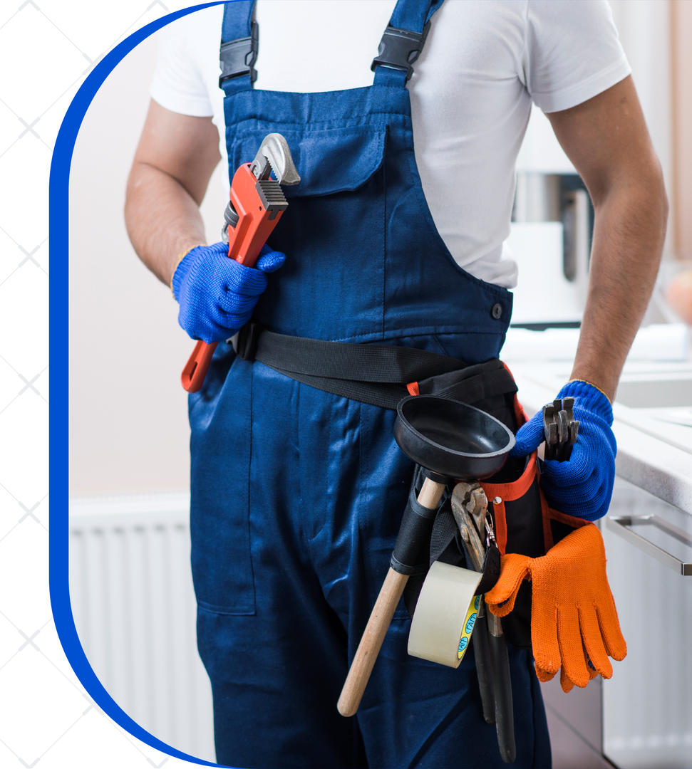 A man in blue overalls is holding a wrench and a plunger