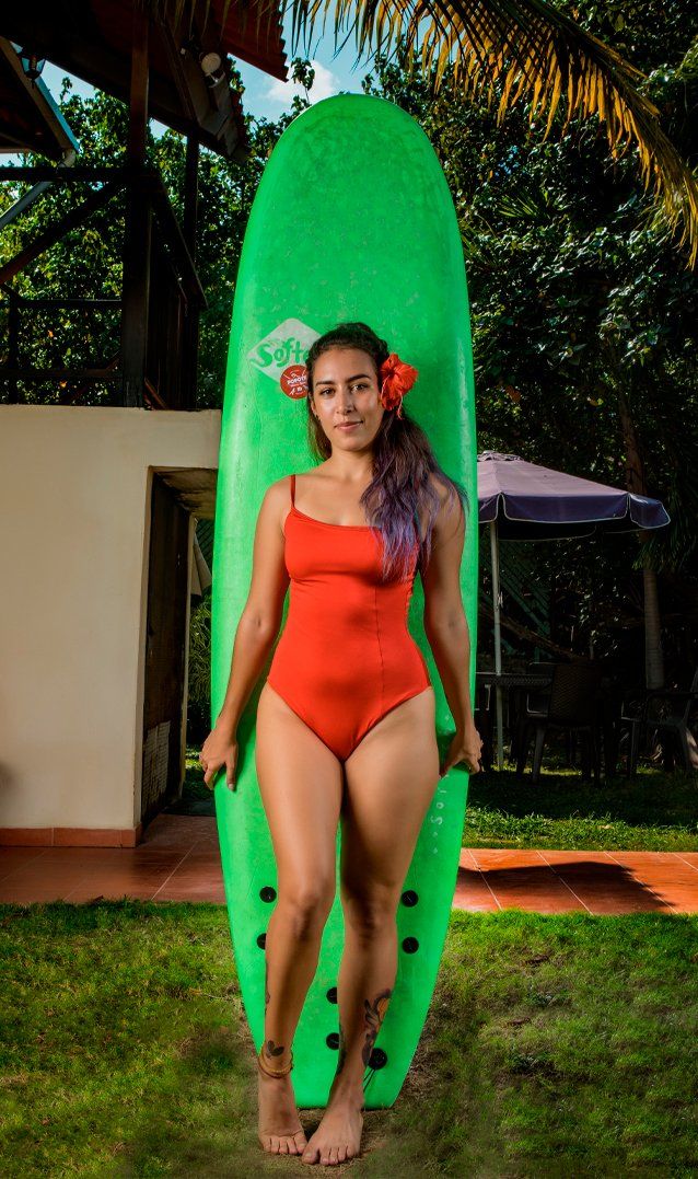 Guest with surfboard at Manglar Lodge near El Palmar Beach Panama