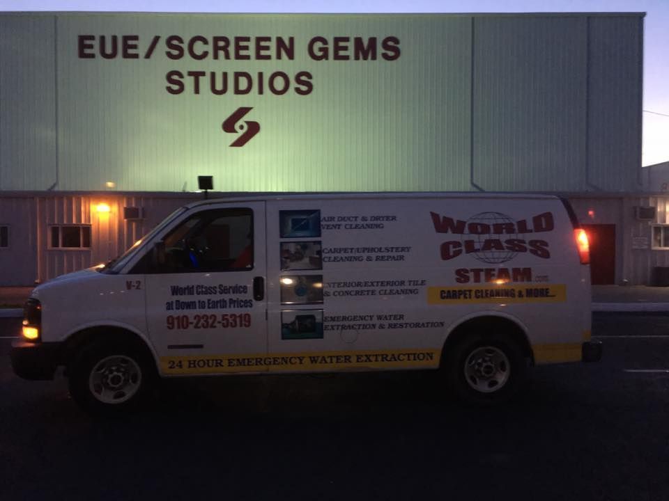 White emergency services truck parked in front of EUE/Screen Gems Studios building at dusk