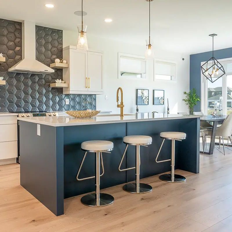 A kitchen with a large island and four stools