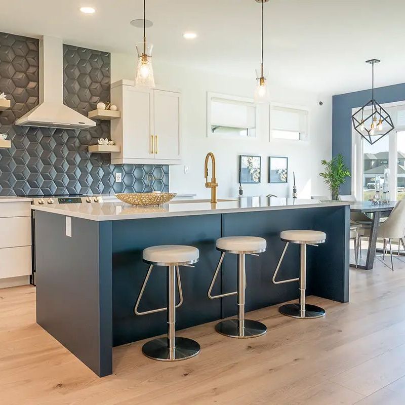 A kitchen with a large island and four stools