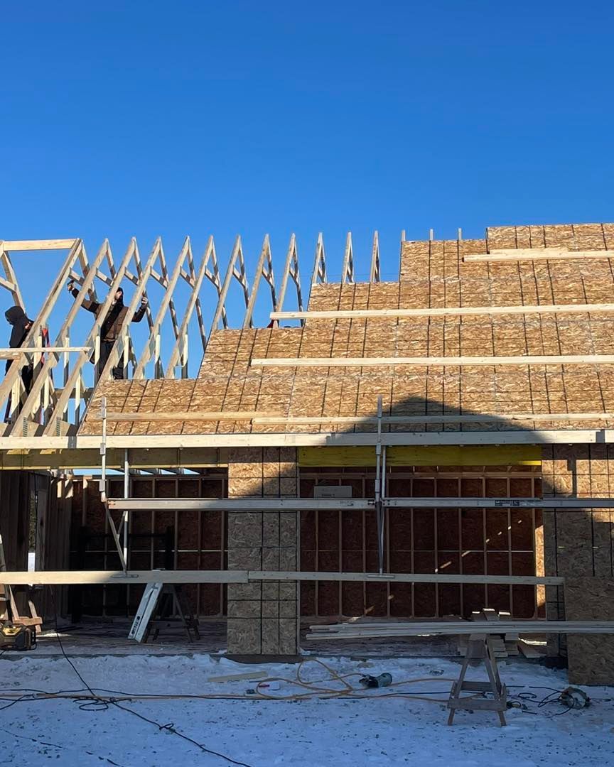 A house under construction with a blue sky in the background