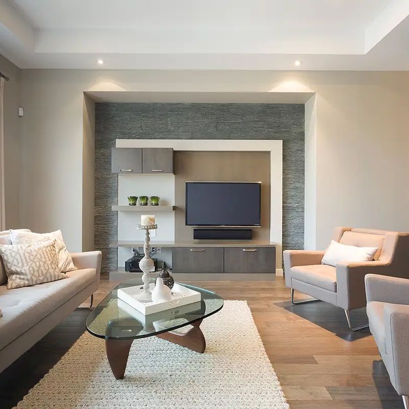 A living room with a couch and chairs and a flat screen tv