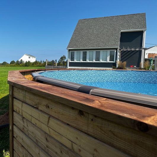 A house with a swimming pool in front of it