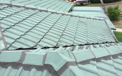 A Green Tiled roof with a Gutter on the Side of it — Roof Repairs in Maitland, NSW