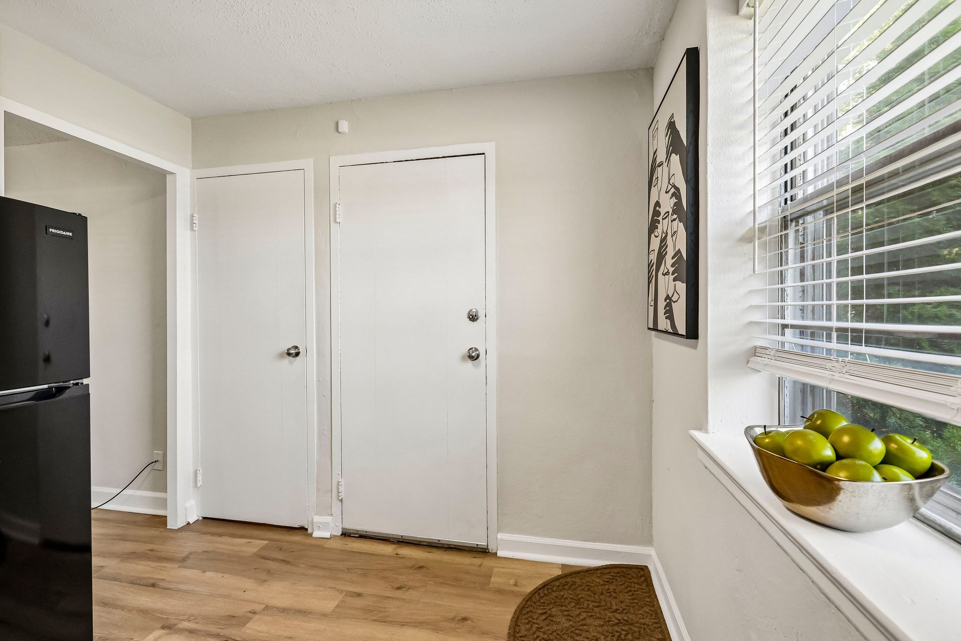Kitchen storage doors beside a large window at Brickline Apartments