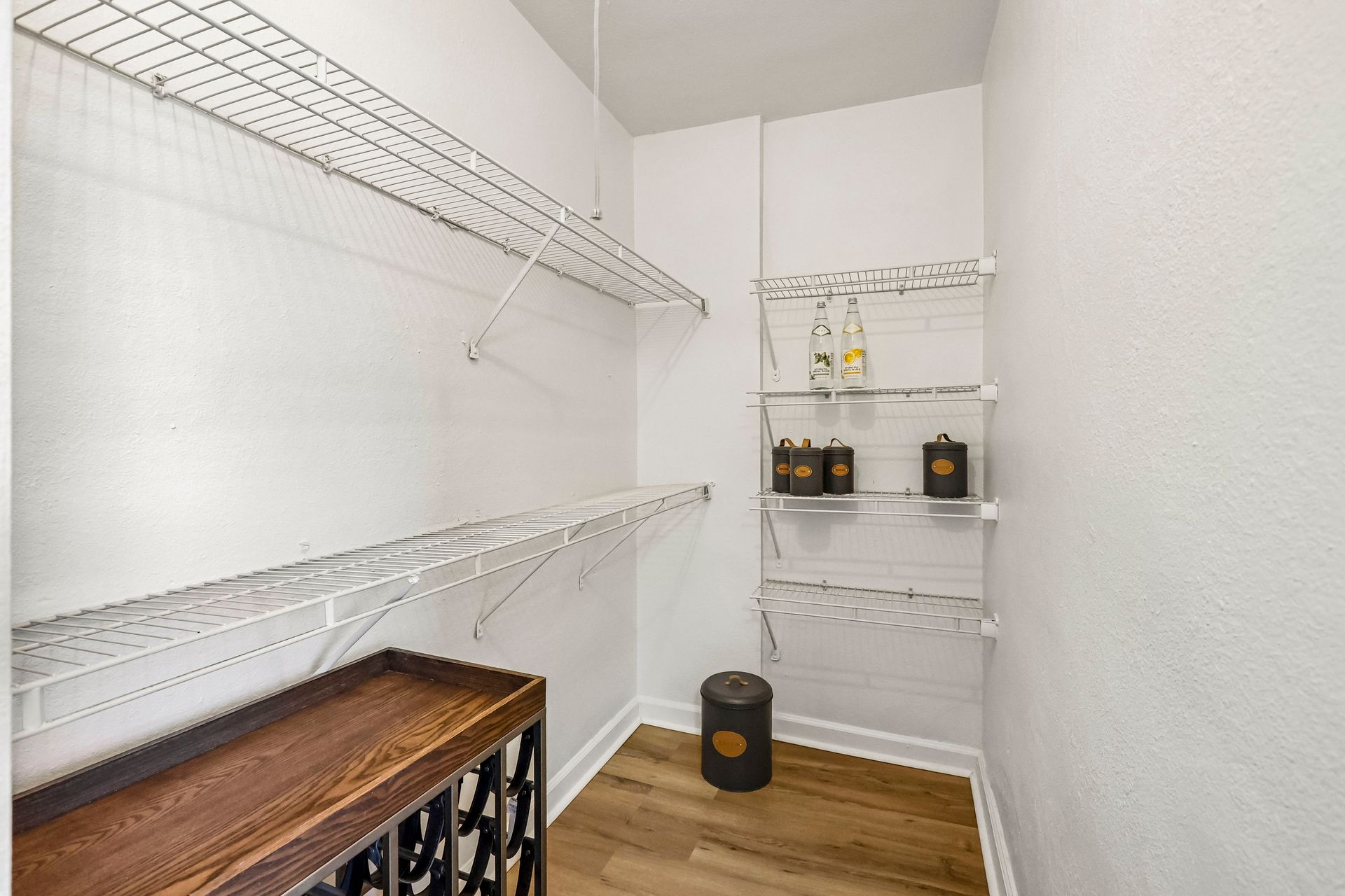 Storage closet with wraparound wire shelving at Brickline Apartments