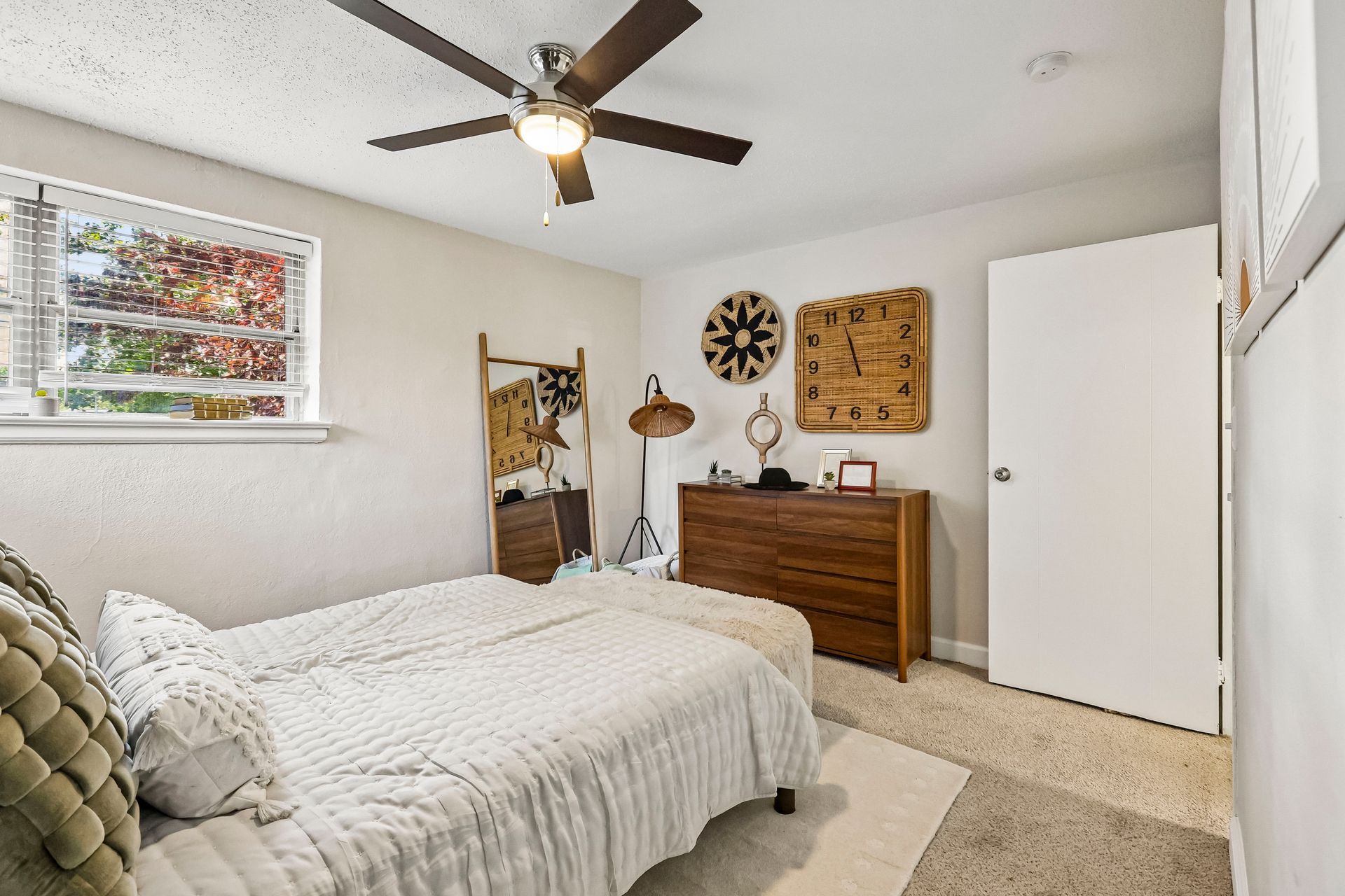 Furnished bedroom with a dresser and dark ceiling fan at Brickline Apartments