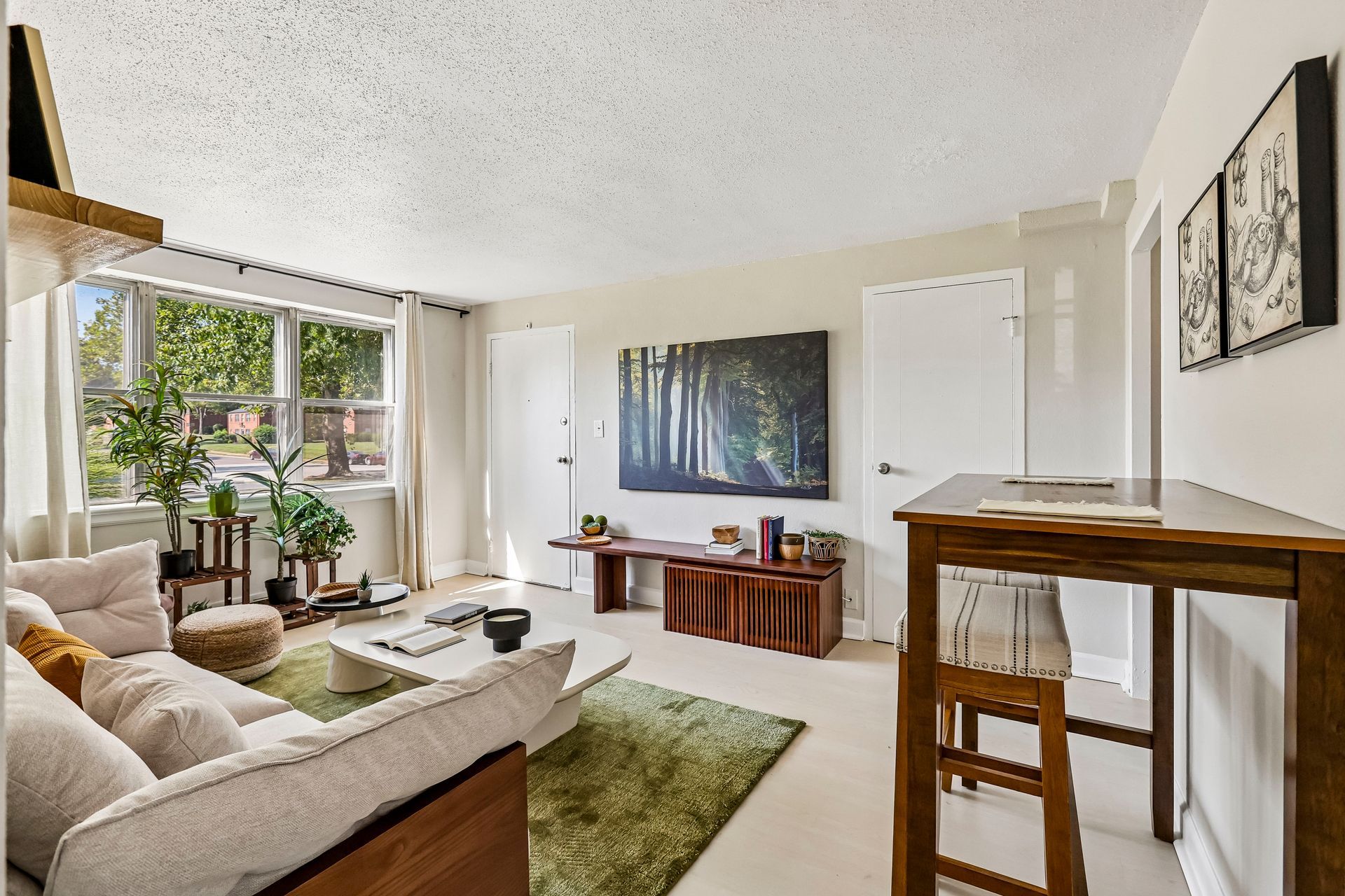 Furnished living and dining area with large windows at Brickline Apartments