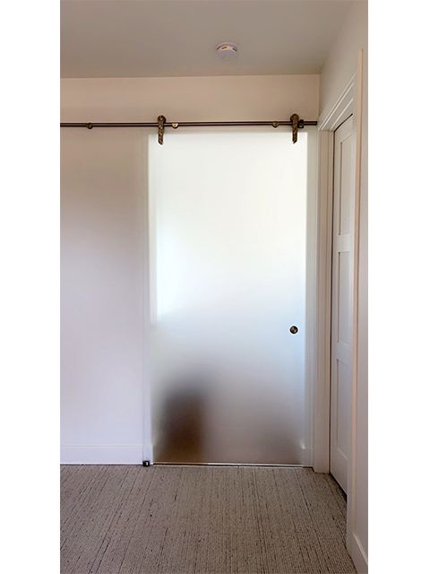A sliding glass door in a room with a carpeted floor.