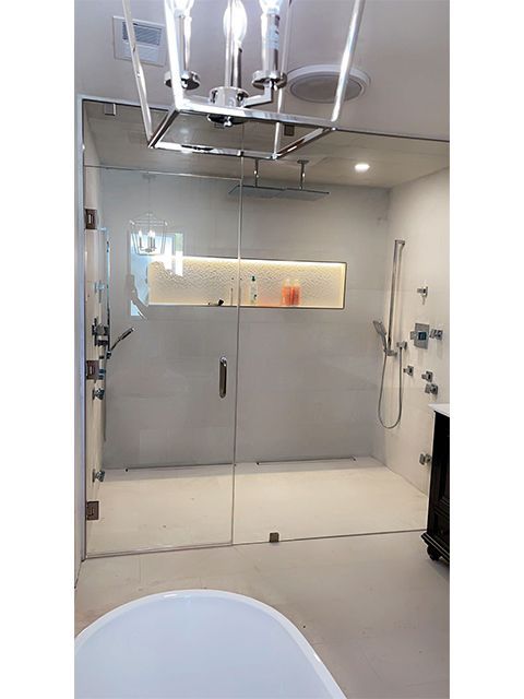 A bathroom with a walk in shower and a bathtub.