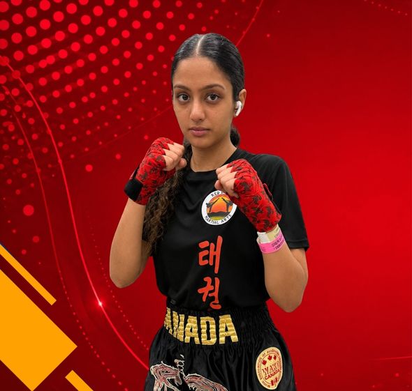 Martial artist in black and red uniform with gloves, posing in a fighting stance against a red graphic background