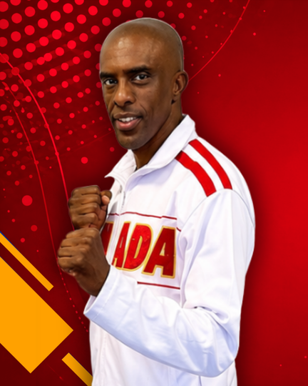 Man in white jacket with red stripes, fists raised, against a red backdrop with Canada text