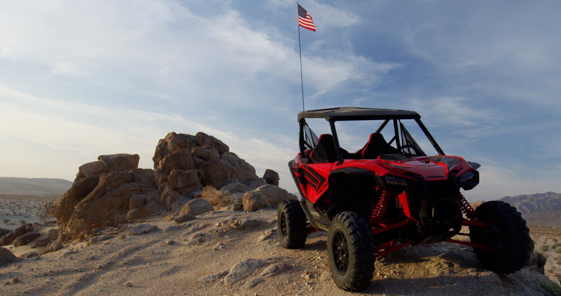 red UTV atop a rocky mountain